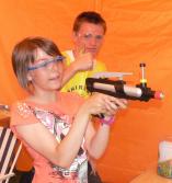 Katrina Whitton takes aim on the paintball, helped by Lion helper Jed Sealey(1)