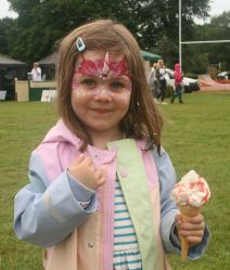 Jemima Edwards enjoys an ice cream after her face painting