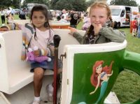 Lily and Tiffany have a spin on the cups ride